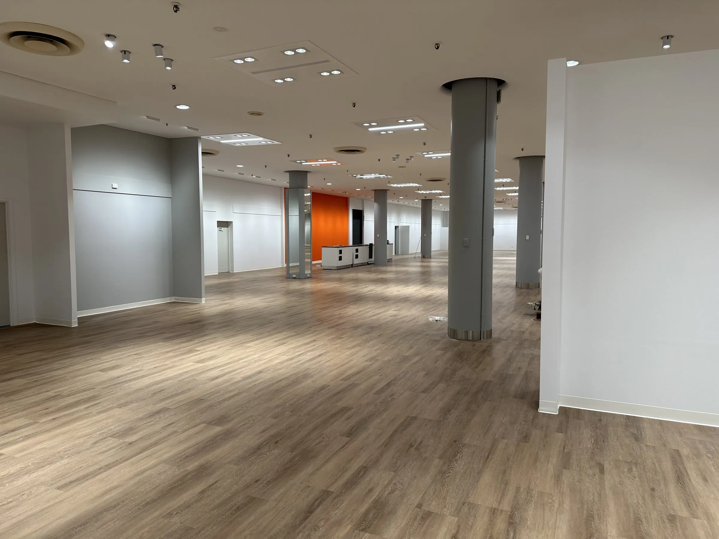 Large open office floor with pillars after a final clean