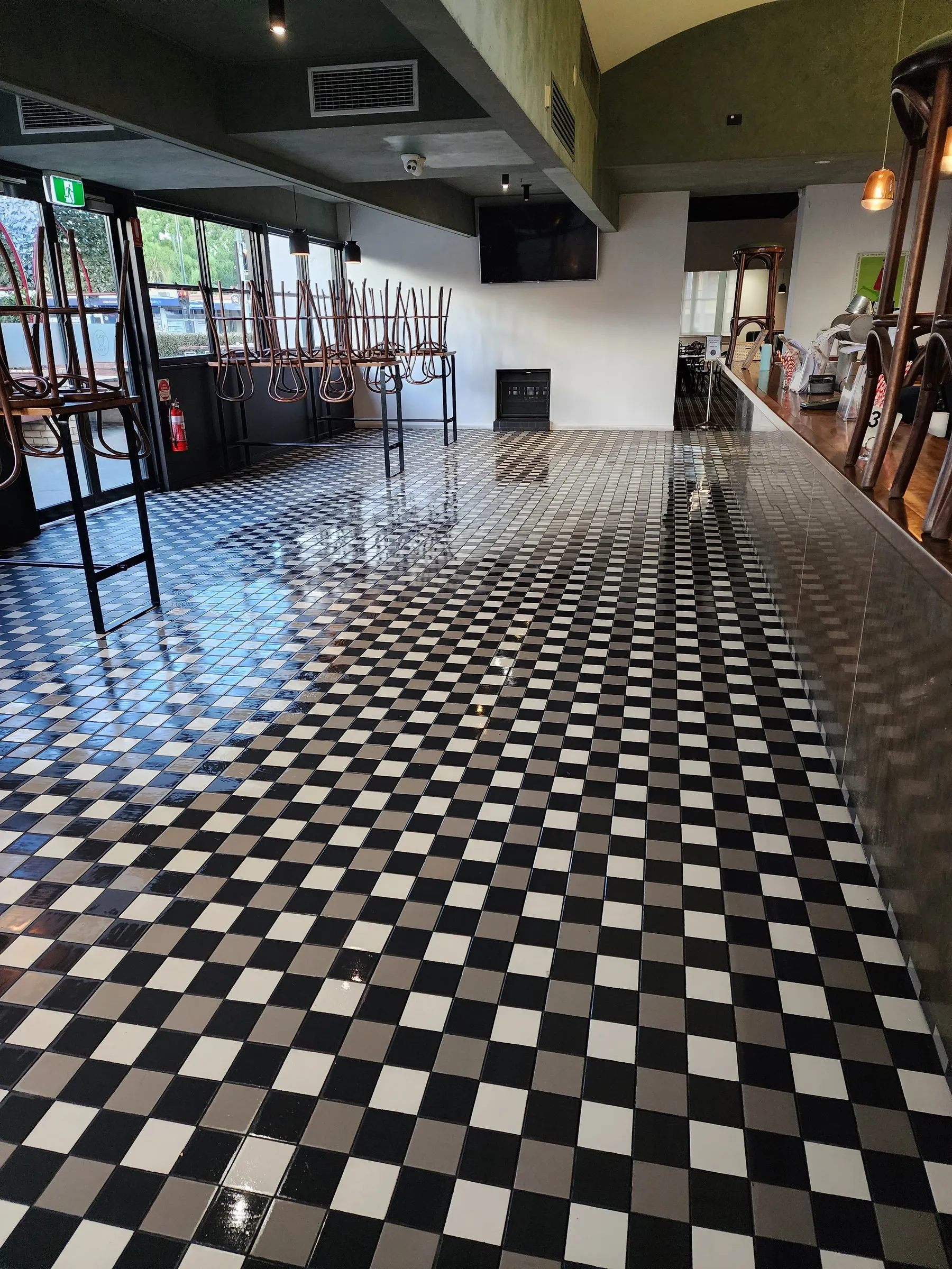 Long black-and-white checkerboard floor gleaming in a heritage pub