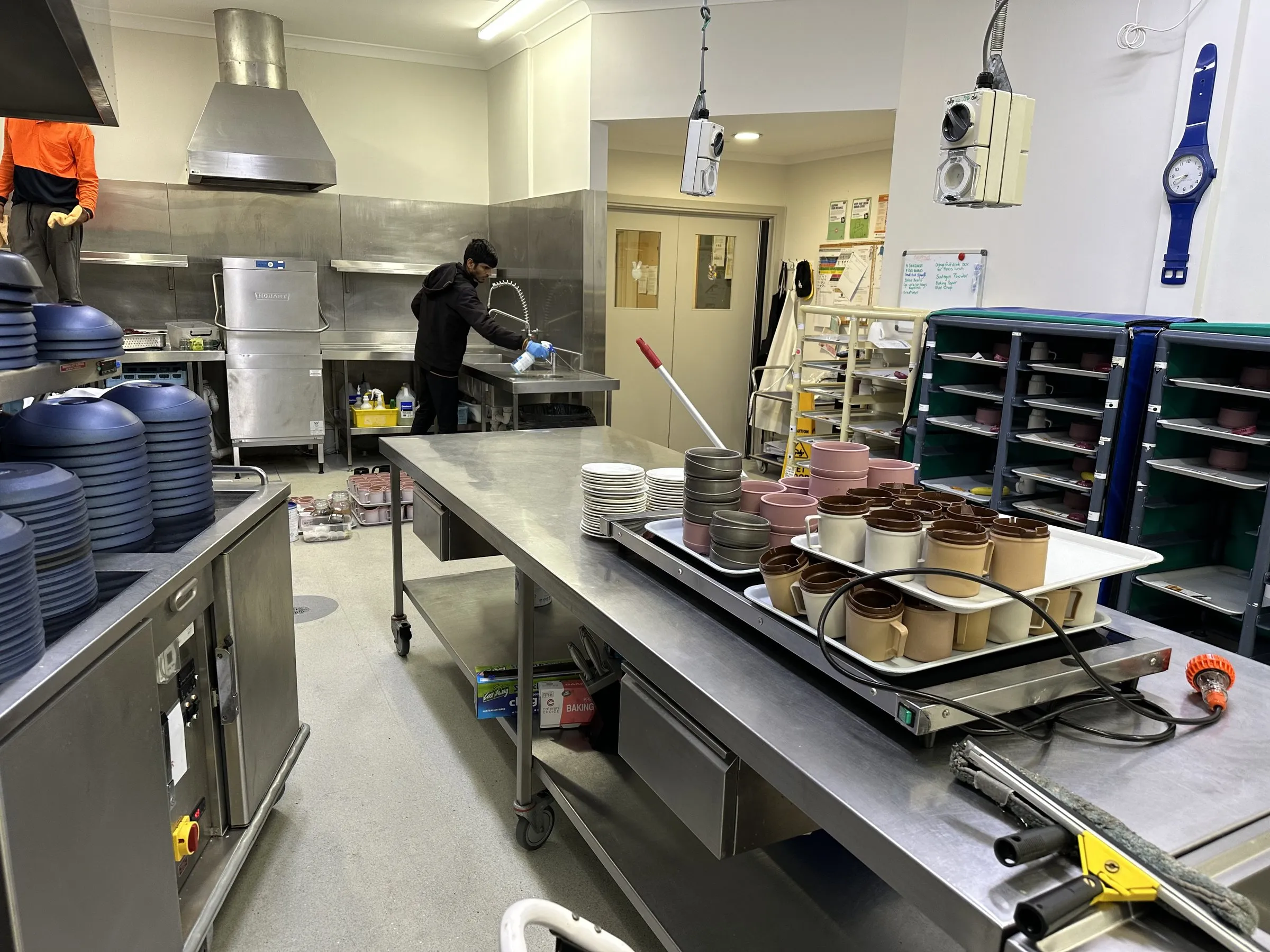 Commercial kitchen being cleaned on a JC job