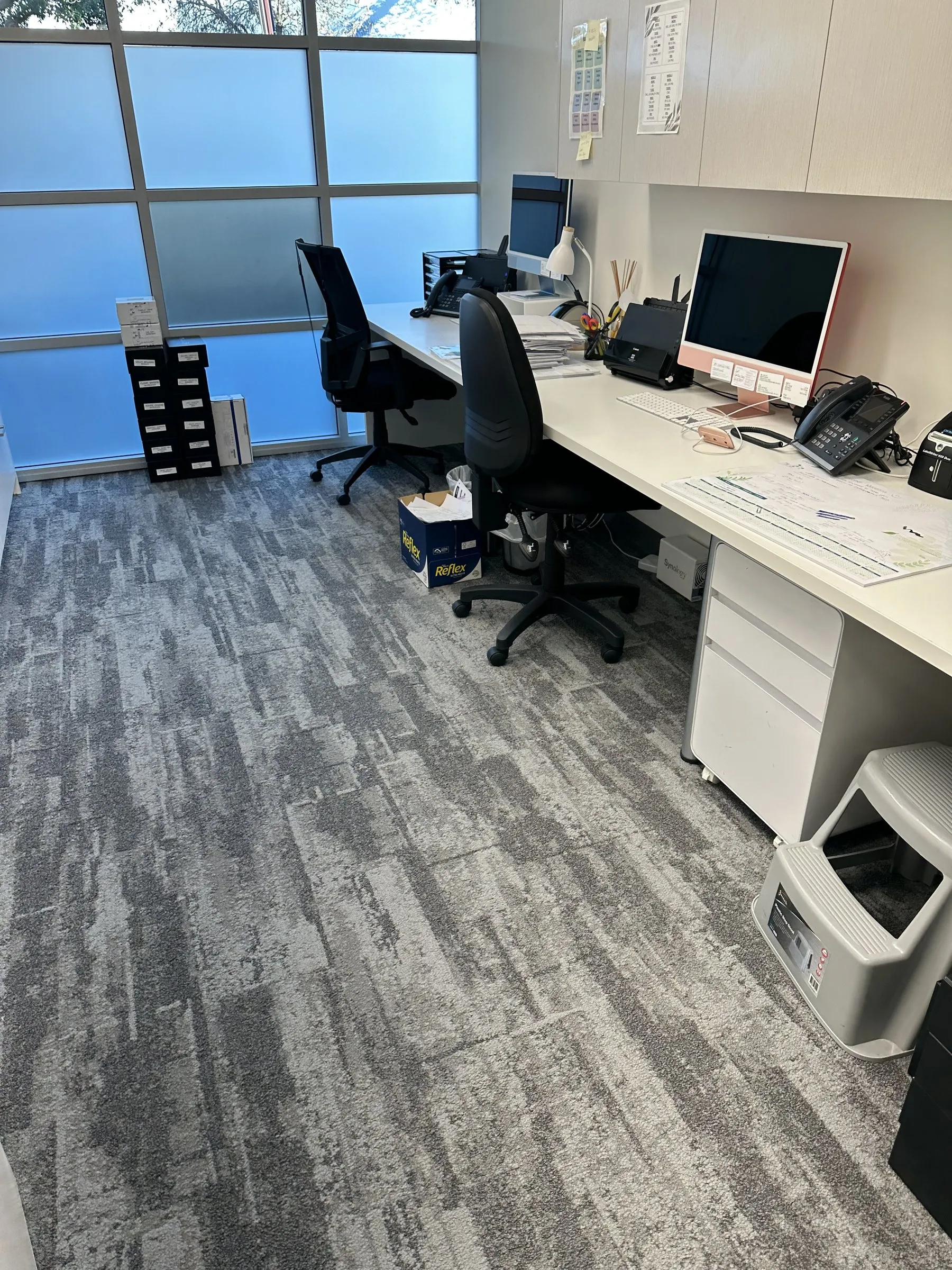 Clean office with carpet tiles and desks after a visit
