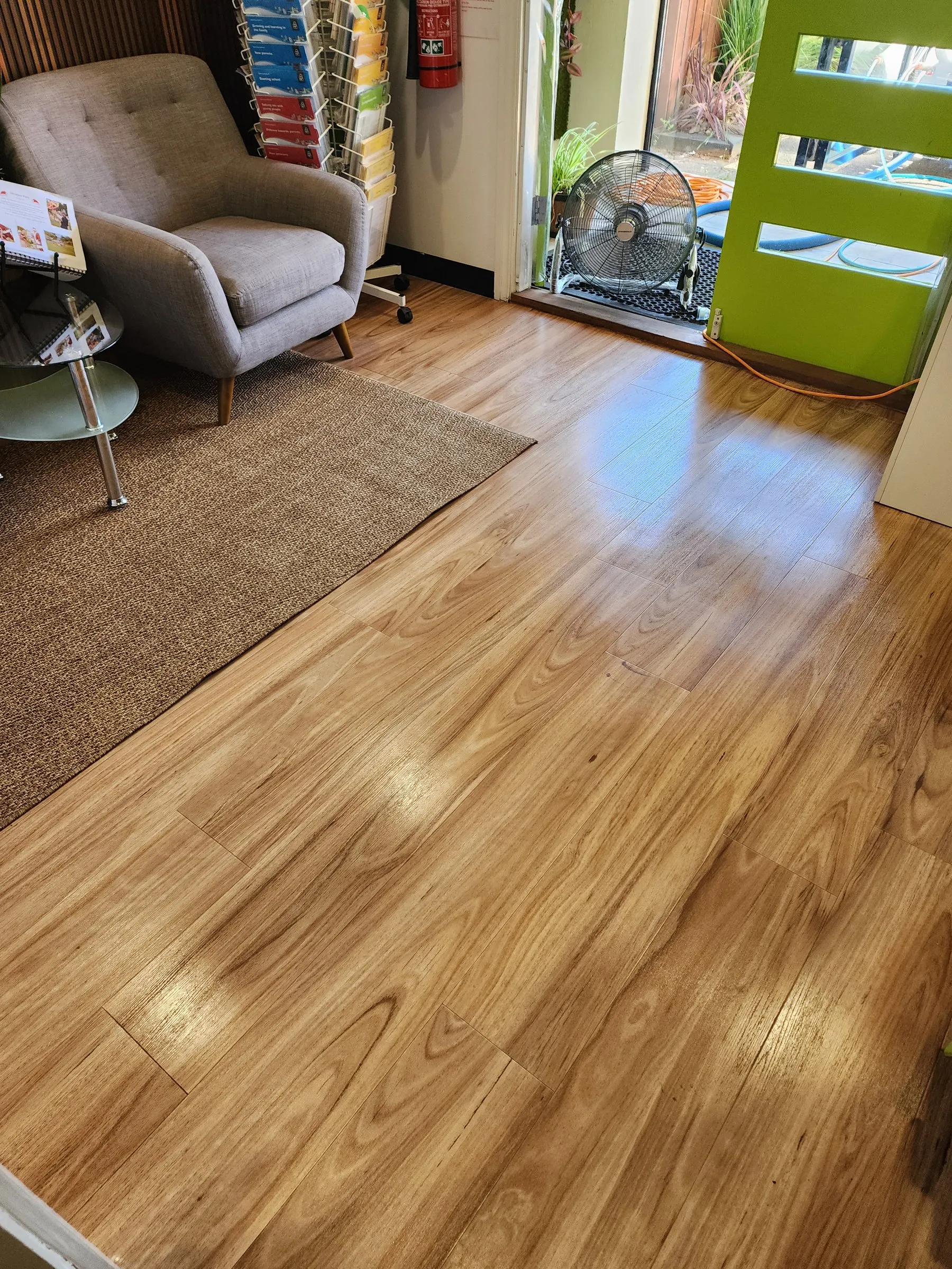 Reception lounge with an armchair and timber floor