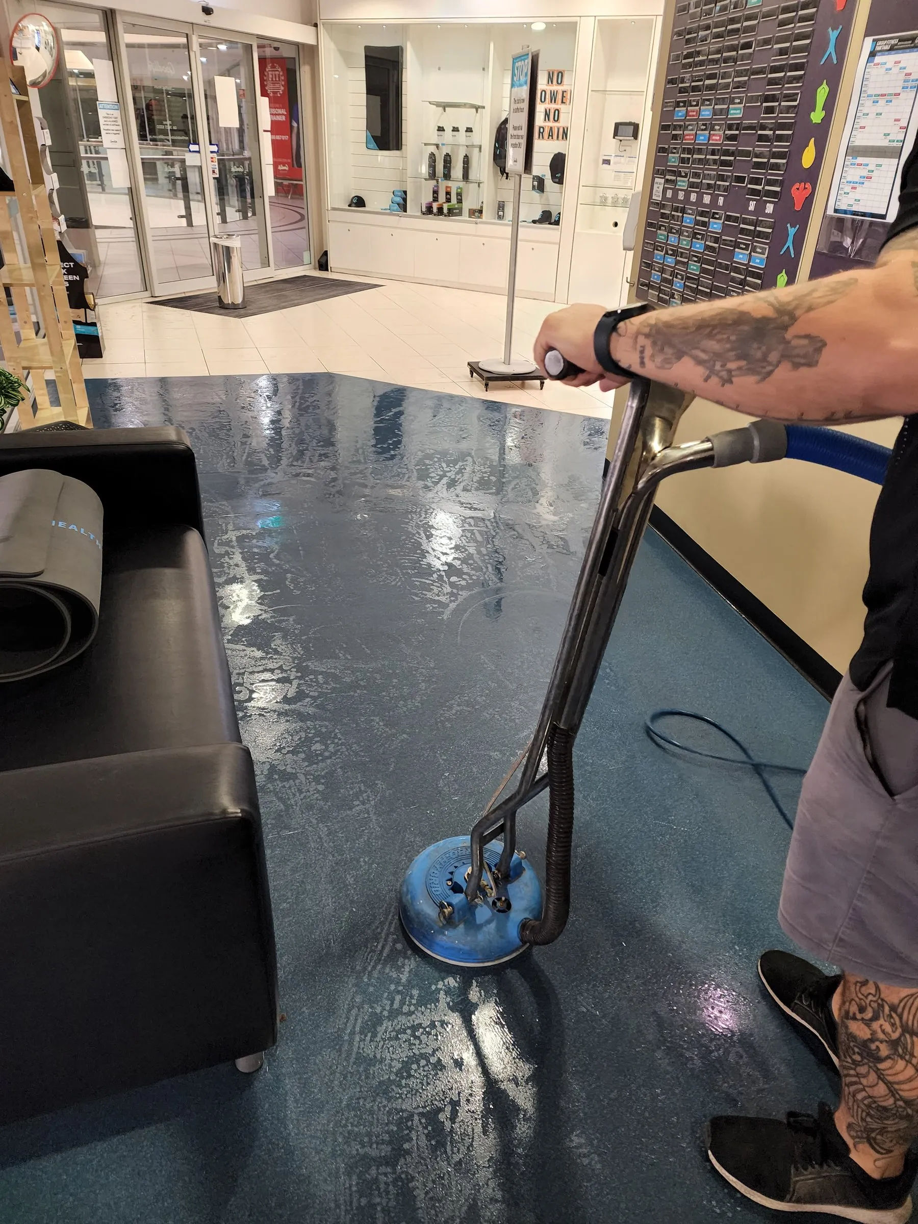 Spinner wand cleaning blue vinyl flooring